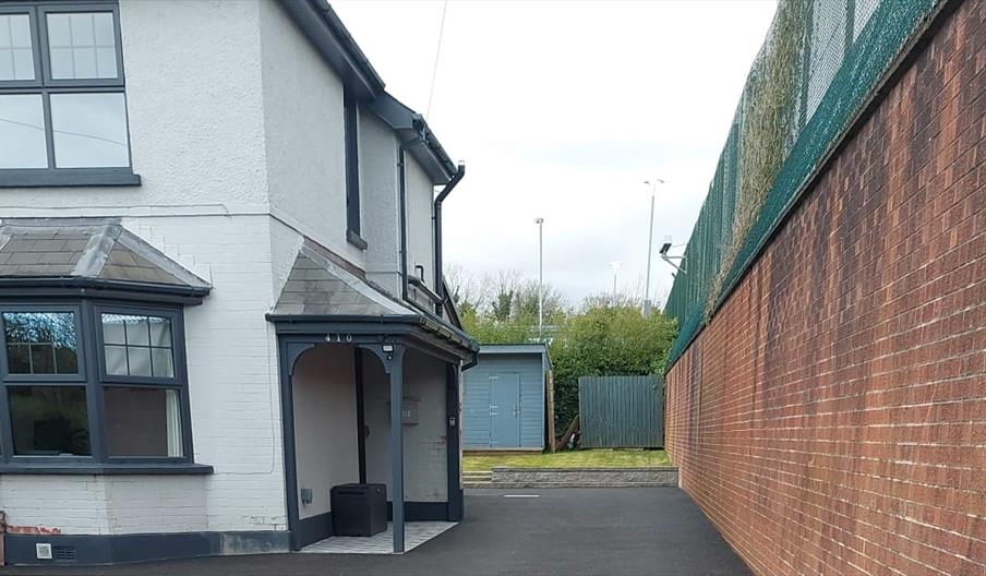 The front of a white house with a Front door veranda.