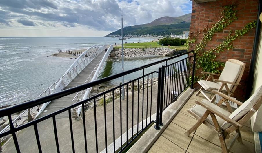 View from balcony with 2 chairs over bridge