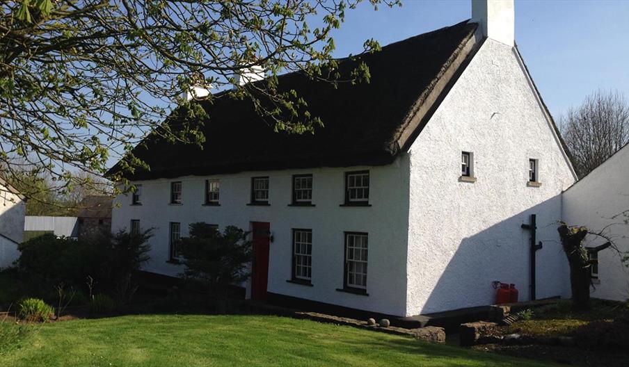 Image is of outside of property with front lawn.