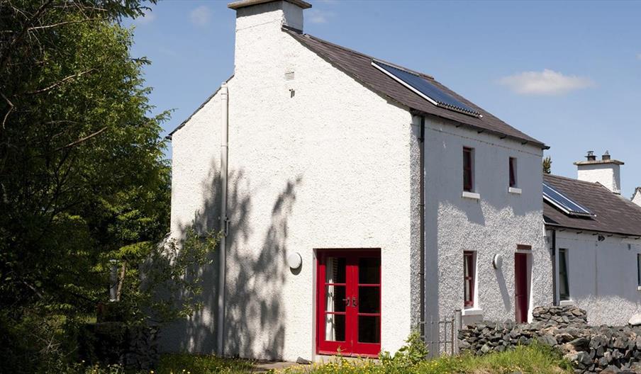 House with red doors and white building