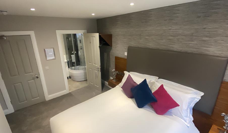 bedroom double bed with side tables and bathroom