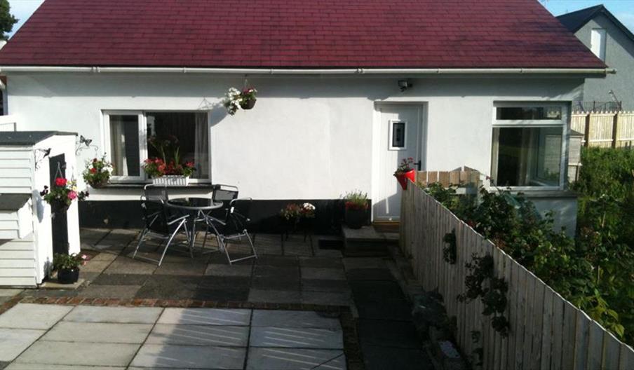 Outside view of Ronan Cottage with table and chairs