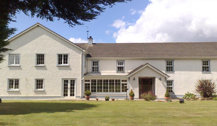 Shows image of front of property and lawn