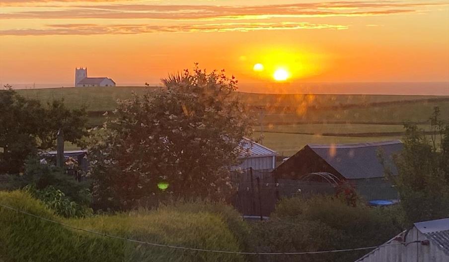 View from the back of the property at sunset looking Northwest towards famous whitewashed church
