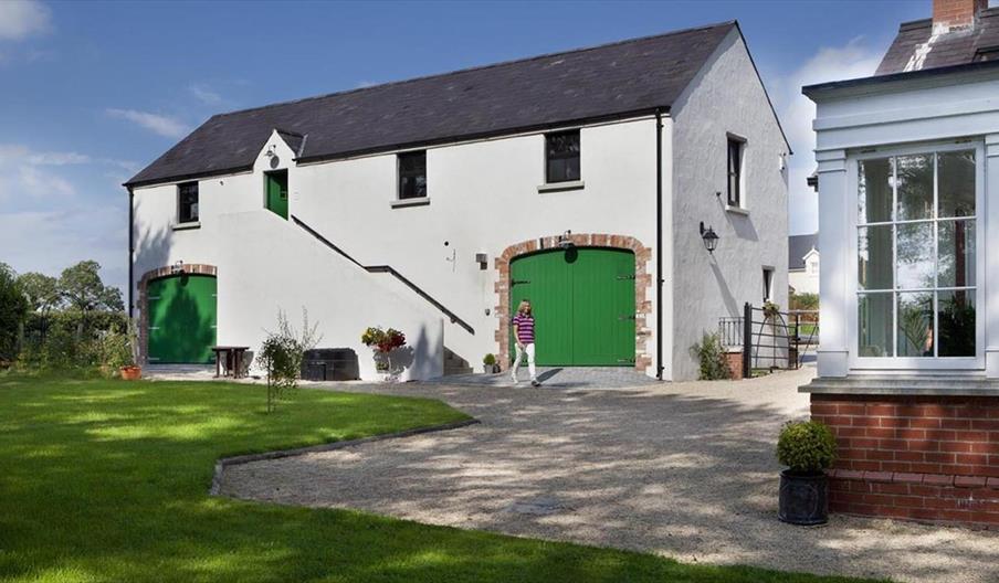 A lady walking outside the Barn at Lisnacurran