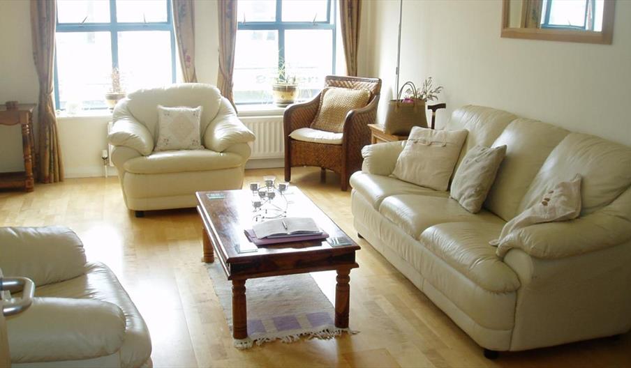 sitting area with 3 seats and a sofa with a table