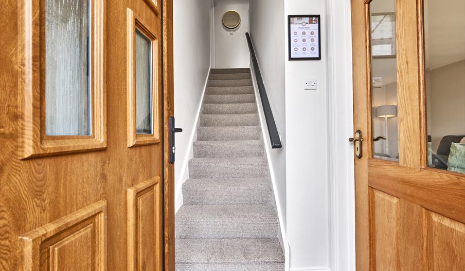 photograph of open front door leading into hall and stairs