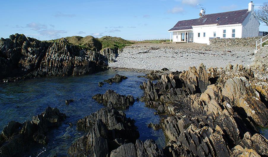 Back exterior with beach and rockshore