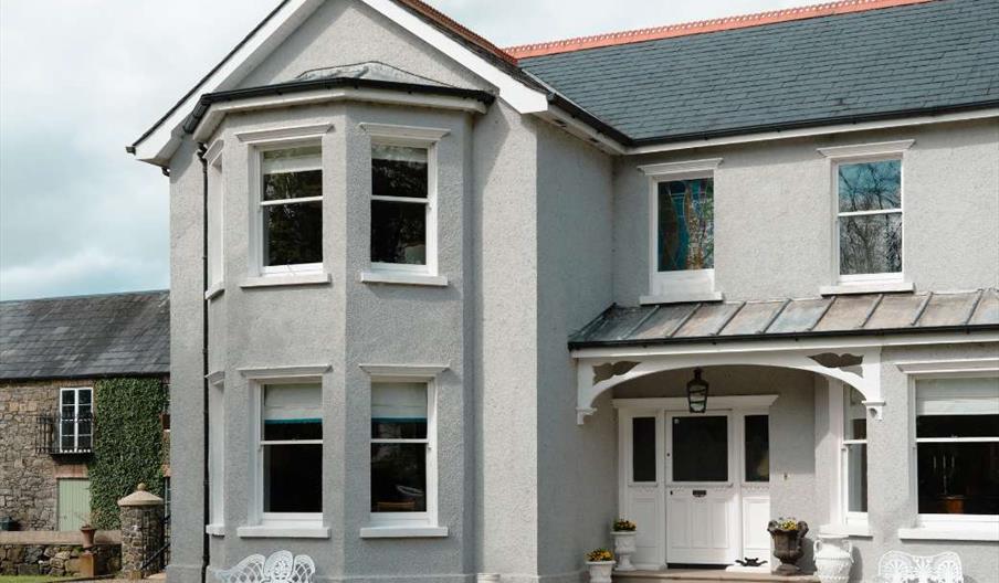 Front of large detached house with courtyard in background