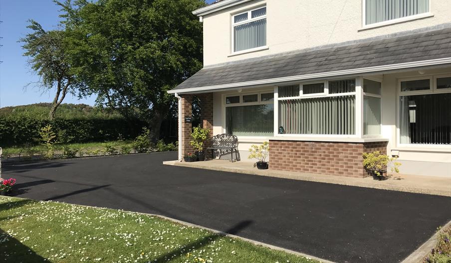 Image of a two story house with flower pots outside