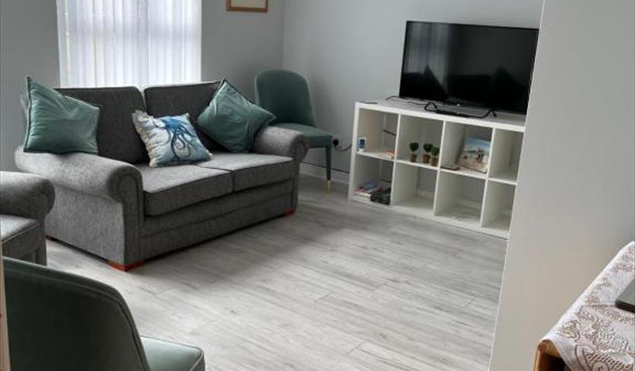 interior of living area at Garden Avenue 2 featuring TV and sofa