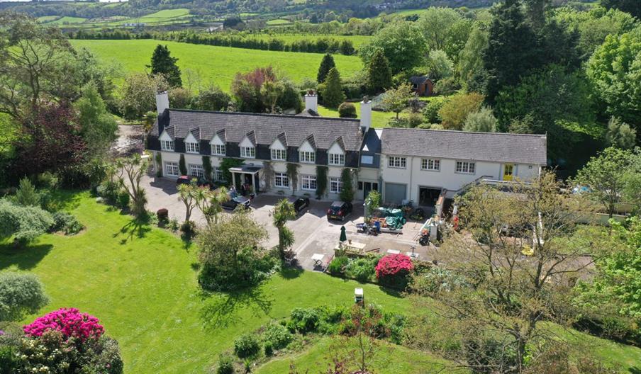 Aerial view of the house and grounds showing lawns to the front of the property