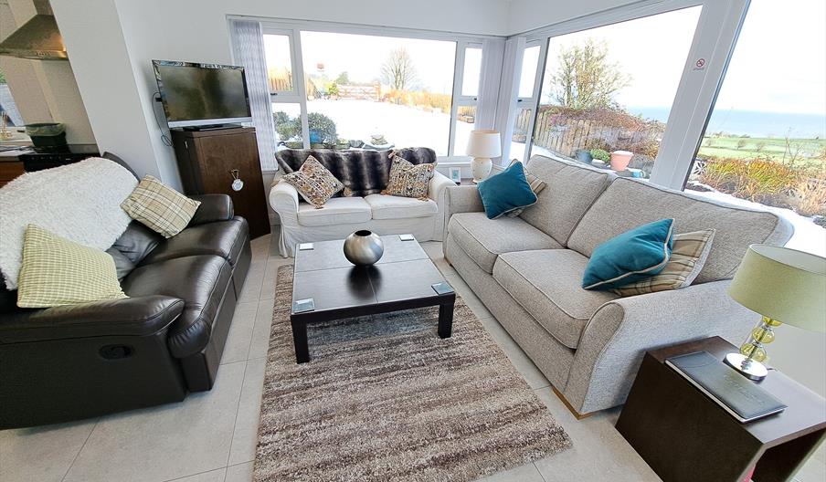 Sitting room area with surround windows and beautiful views.
