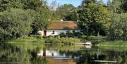 A longshot of the cottage over Keenaghan Lough.