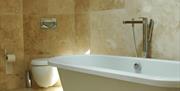 Bathroom with freestanding rolltop bath