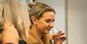 Customer sampling McConnell's Irish Whisky at the distillery.
