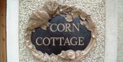 a photo of a sign saying corn cottage