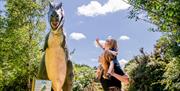 A mum and child looking thrilled at the Dinosaur trail at the ark open farm