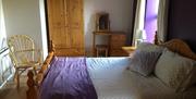 bedroom double bed with side tables and wardrobe