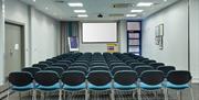 Meeting room in Holiday Inn Express Belfast City, view from the back of the room. It is set up theatre style with multiple rows of chairs.