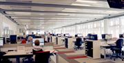 Interior photograph of the PRONI Search Room showing dozens of computer screens at separate desks.