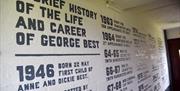 White wall painted with George Best football facts